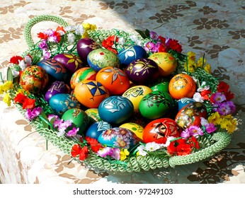 A bunch of beautiful painted easter eggs in basket
