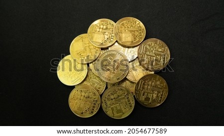 a bunch of bitcoin gold coins piling up and scattering with black background