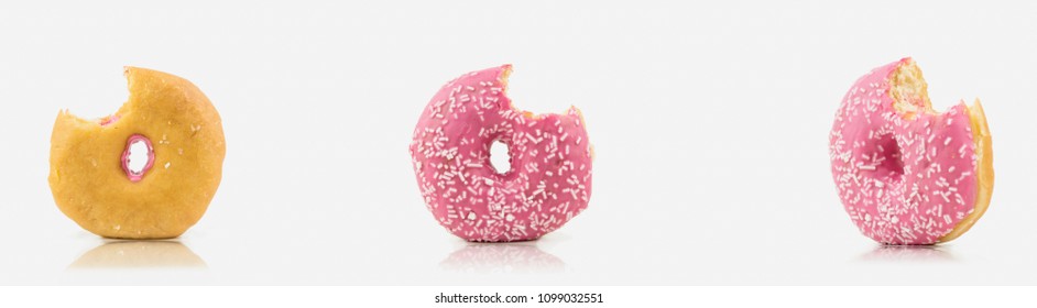Bunch Of Bitten Delicious Pink Colored Donut On White Background With White Chocolate On It.Isolated On White