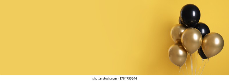Bunch Of Black And Gold Balloons On Yellow Background, Space For Text. Banner Design 