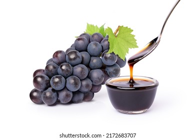 Bunch Of Black Grape With Green Leaf And Grape Molasses In Glass Bowl Isolated On White Background.