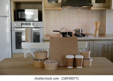 Bunch Of Blank Disposable Containers For Takeout Food Stacked With Paper Bags, Cups And Boxes With Copy Space For Brand's Logo. Close Up Shot Of Eco Friendly To Go Carton Bowls On Table.