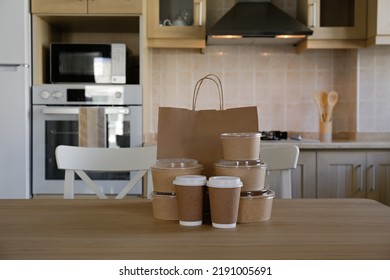 Bunch Of Blank Disposable Containers For Takeout Food Stacked With Paper Bags, Cups And Boxes With Copy Space For Brand's Logo. Close Up Shot Of Eco Friendly To Go Carton Bowls On Table.