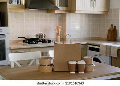 Bunch Of Blank Disposable Containers For Takeout Food Stacked With Paper Bags, Cups And Boxes With Copy Space For Brand's Logo. Close Up Shot Of Eco Friendly To Go Carton Bowls On Table.