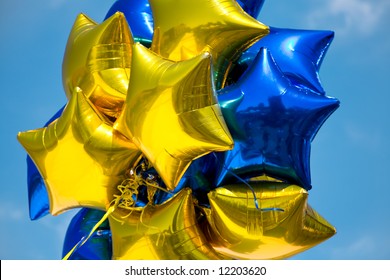 Bunch Of Blue And Yellow Mylar Balloons With Sky Background