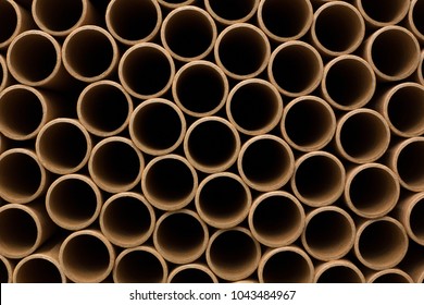 A Bunch Of Brown Industrial Paper Core. A Lot Of Paper Cores Or Paper Tubes. Brown Paper Rolls.