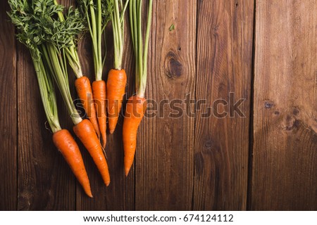 A bunch of carrot on a wooden background