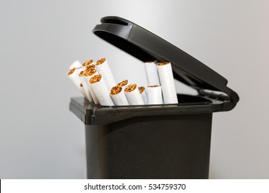 Bunch of cigarettes in the trash bin. Quit smoking concept