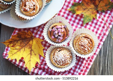 A Bunch Of Cinnamon Buns On A Kitchen Towel