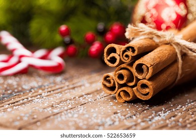 Bunch Of Cinnamon Sticks On Wooden Table. Christmas Time