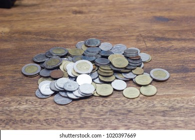 Bunch of coins on the wood, isolated, side view, financial concept - Shutterstock ID 1020397669