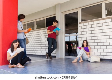 Bunch Of College Students Waiting In The Hallway Outside A Classroom And Studying Before A Test