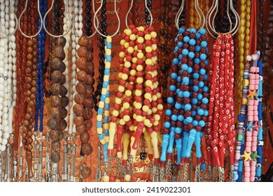 A bunch of colorful beads hanging for display. - Powered by Shutterstock