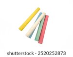 A bunch of colorful, yellow, white, blue, green and pink chalk sticks isolated on a white background