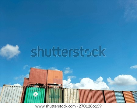 a bunch of containers in the clear sky