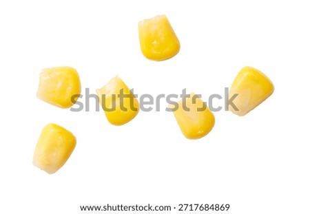 A bunch of corn kernels are shown in a row. The corn is yellow and has a slightly curved shape