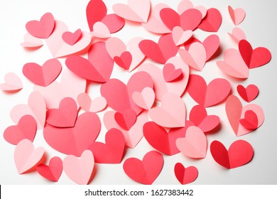 Bunch of cut out of pink and red paper hearts on white background. Good Valentines day, Womans day, love, romantic or wedding card, banner, invitation background for banner, congratulation, card