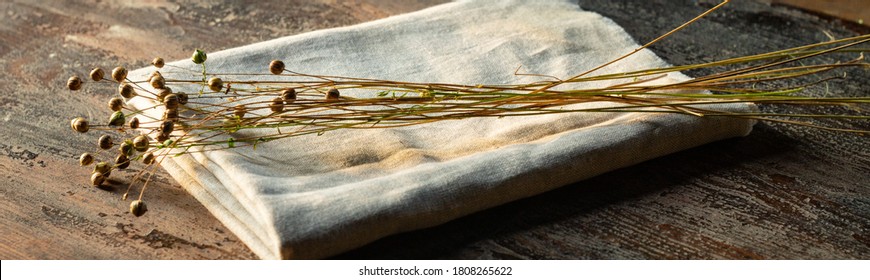 Bunch Of Dry Flax Plants On Linen Textile