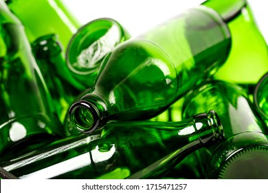 A bunch of empty green glass bottles collected for recycling sale. Waste management concept.
