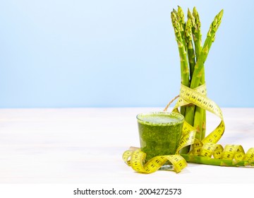 Bunch Of Fresh Asparagus On Blue Background With Measuring Tape. Ketogenic Diet Food With Vitamins And Cellulose. Green Vegetable. Copy Space. Clean Eating Concept