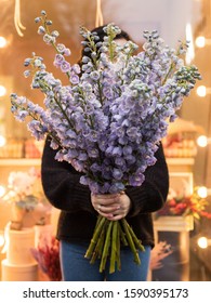 Bunch Of Fresh Delphinium. Woman Florist Holds A Bouquet Of Purple Delphinium. 