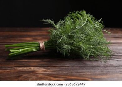 Bunch of fresh dill on wooden table - Shutterstock ID 2368692449