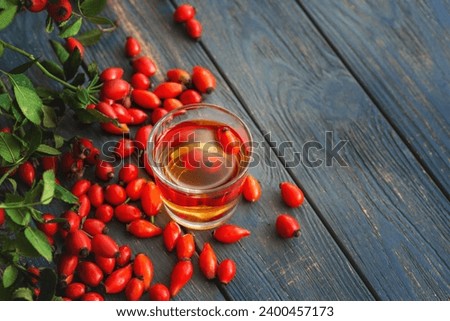 bunch of fresh dog rose, Rosa canina, rosehip and herbal tea cup - selective focus. room for text	