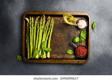 A bunch of fresh green asparagus on a metal tray. Cooking asparagus dishes. Top view. - Powered by Shutterstock