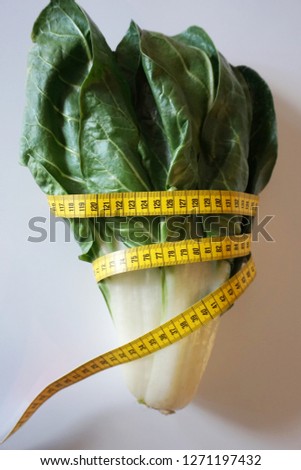 Image, Stock Photo Fresh leaf salad with a measuring tape on a board