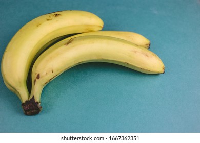 Bunch Of Fresh Ripe Bananas On A Green Background. Food Concept. Delicious Healthy Fresh Yellow Banana.  Sports Food And Nutrition, Healthcare And Organic Fair Trade Concept.