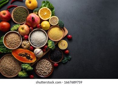 Bunch of fresh seasonal fruits, vegetables and grains of legumes on a black background	
 - Shutterstock ID 1667689759