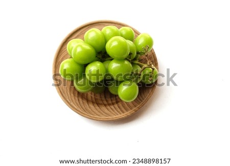 Bunch of fresh Sweet Green Shine Muscat (Vitis vinifera) grape and leaf  isolated on white backdrop.green grapes. 
Japanese grapes.Grapes green taste sweet growing natural.