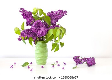 Bunch Of Fresh  Violet Syringa Vulgaris In Lilac Flower  In Green Ceramic Vase.Creative Concept.