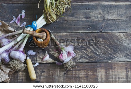 Image, Stock Photo Bunch of garlic with kitchenware on wooden background