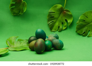 Bunch of green Easter egg on green background. Monochromatic com