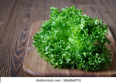 Bunch of green lettuce on wooden board  