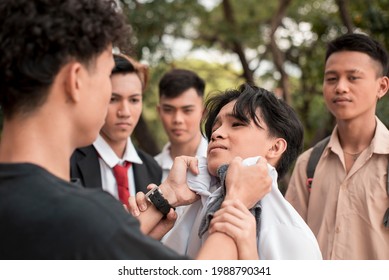 A Bunch Of High School Delinquents Bully A Smaller Boy. One Bully Grabs Him By The Collar. Emotional And Physical Abuse Issues In Teenagers.