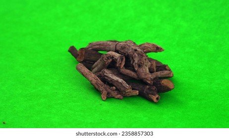 Bunch of Indian madderwort or madder root on the brown colored wooden surface also known as manzistha, Rubia cordifolia, madder etc. with various health benefits derived from ancient Ayurveda