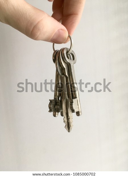 A bunch of keys\
in hand on white background