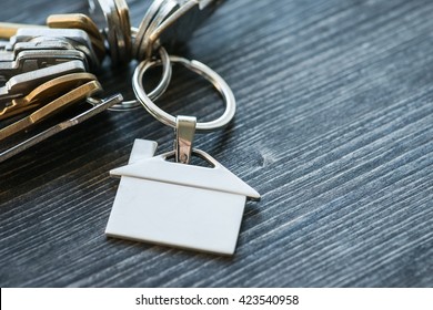 Bunch Of Keys With House Shaped Key Ring On A Rustic Wooden Table