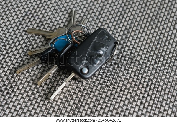 Bunch of keys on the table. Car, bike and\
apartment keys on texture\
table.