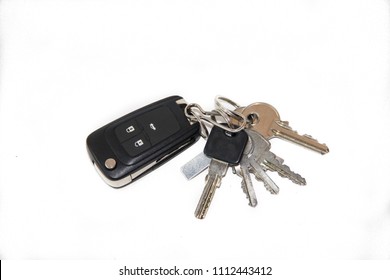 A bunch of keys on a white background. Keys from the car, the keys to the apartment.