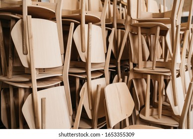 Bunch of light wooden chairs in storage for manufacturing furnutire