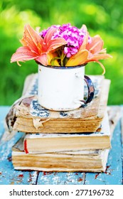 Bunch Of Lily Flowers On Old Vintage Book In The Garden