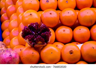 a bunch of mandarin clustered in rows and decorated with open and succulent nar