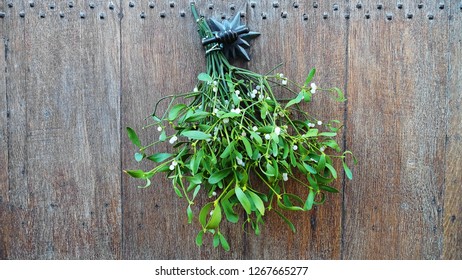 A Bunch Of Mistletoe Hanging On A Door