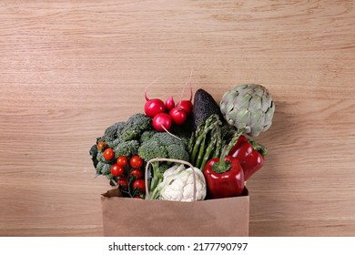 Bunch Of Mixed Vegetables, Herbs And Greens In A Brown Paper Bag. Vegan Diet Products. Clean Eating Concept. Eco Friendly Bag Full Of Groceries. Close Up, Copy Space, Background, Top View, Overhead