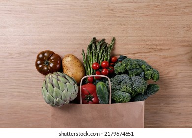 Bunch Of Mixed Vegetables, Herbs And Greens In A Brown Paper Bag. Vegan Diet Products. Clean Eating Concept. Eco Friendly Bag Full Of Groceries. Close Up, Copy Space, Background, Top View, Overhead