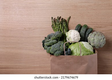 Bunch Of Mixed Vegetables, Herbs And Greens In A Brown Paper Bag. Vegan Diet Products. Clean Eating Concept. Eco Friendly Bag Full Of Groceries. Close Up, Copy Space, Background, Top View, Overhead