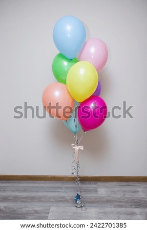 bunch of multi-colored balloons on a white background